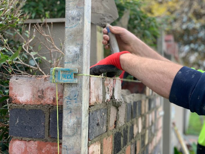 Bricklayers gold coast installing a brick fence in Broadbeach