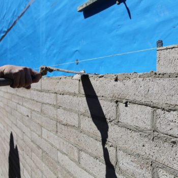 Image is of Gold Coast Pro Bricklayers working on a brick fence